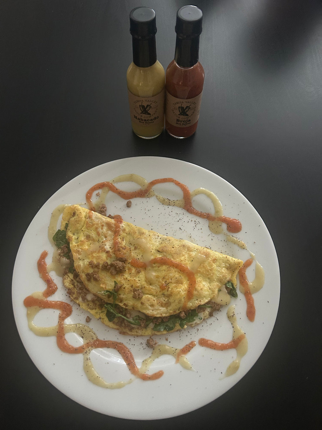 omellete with hot sauce on a white plate