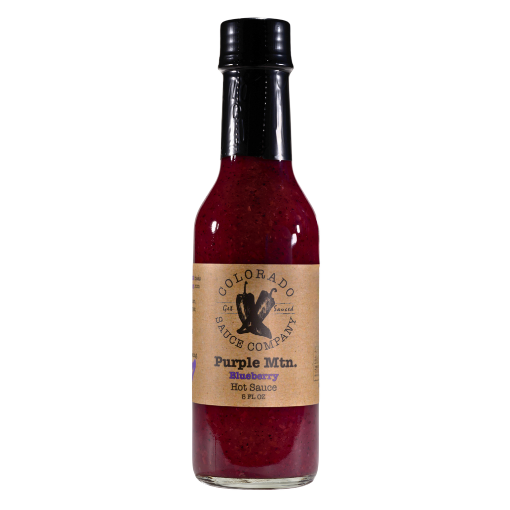 Bottle of Colorado Sauce Company Purple Blaze Blueberyy Hot Sauce with no background
