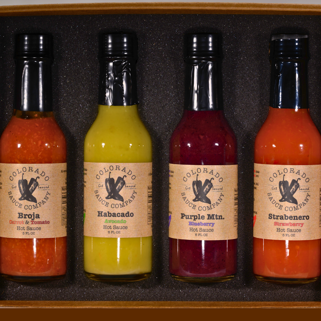 Four bottles of Colorado Sauce Company hot sauce in a set (trophy case)