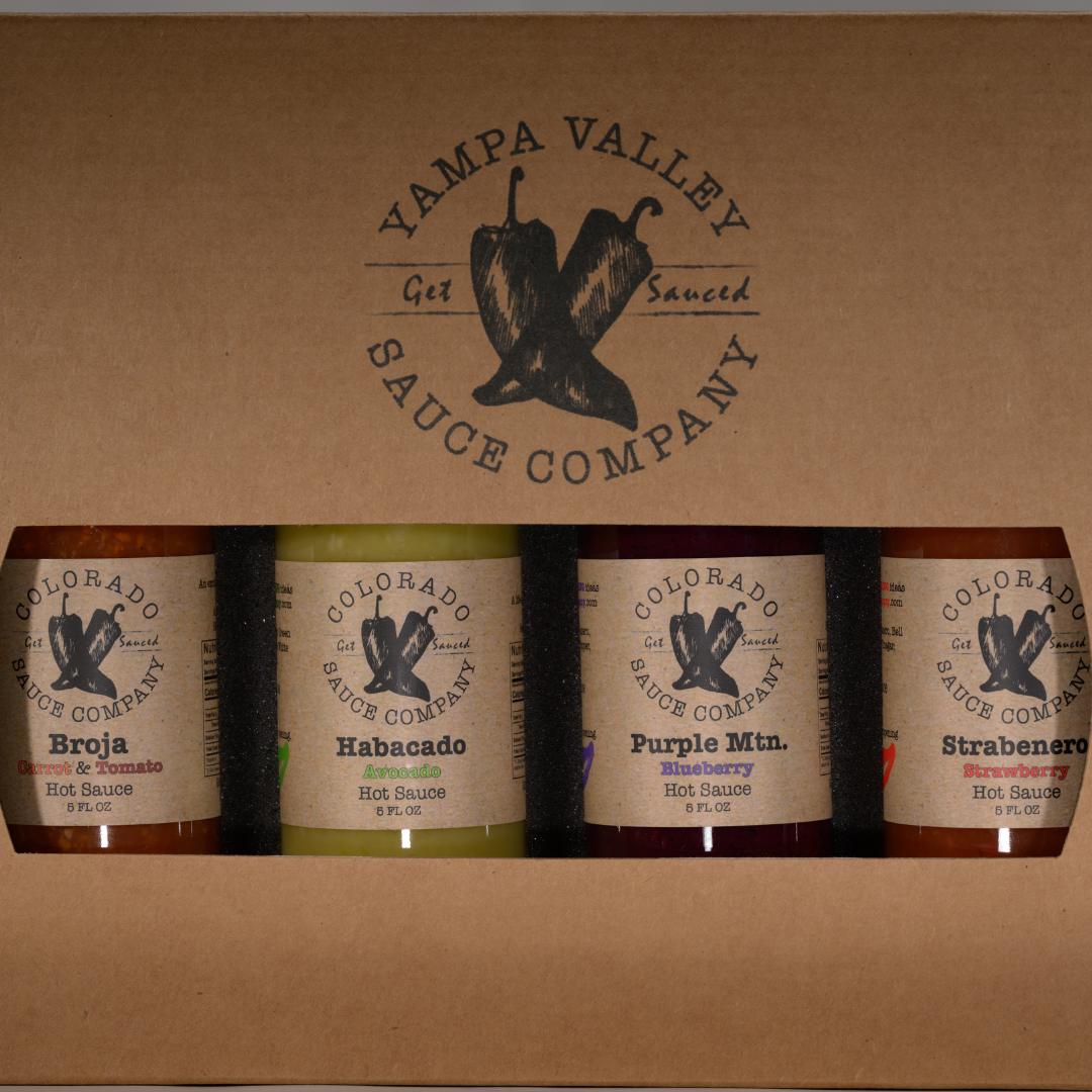 four bottles of Colorado Sauce Company hot sauces in trophy case box